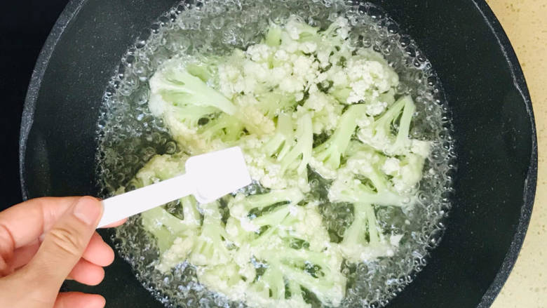 椒盐花菜,加入锅里，烧开水焯水，期间继续撒入少许盐