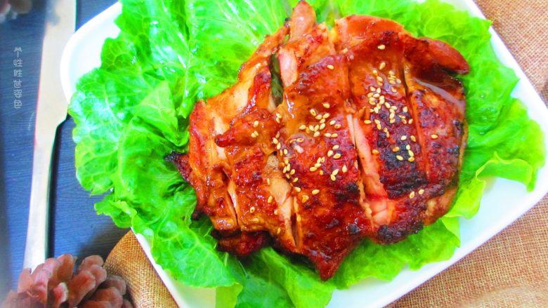 碳烤鸡腿肉,把生菜扑在盘子里，放上烤好的鸡腿，用刀切开，撒上白芝麻即可开吃