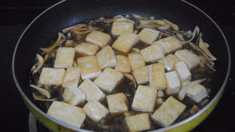 鸡枞菇烧豆腐,倒入豆腐焖煮1分钟，加入适量盐进行调味