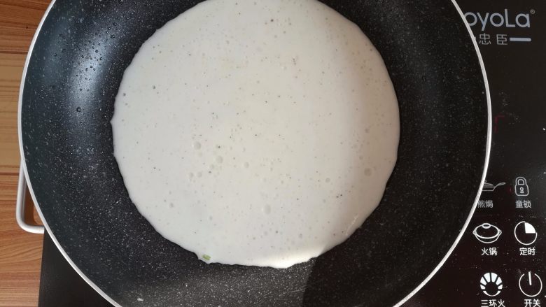 野葱鸡蛋饼儿,不粘锅里刷一点点油，倒入适量的面糊，平铺满锅底