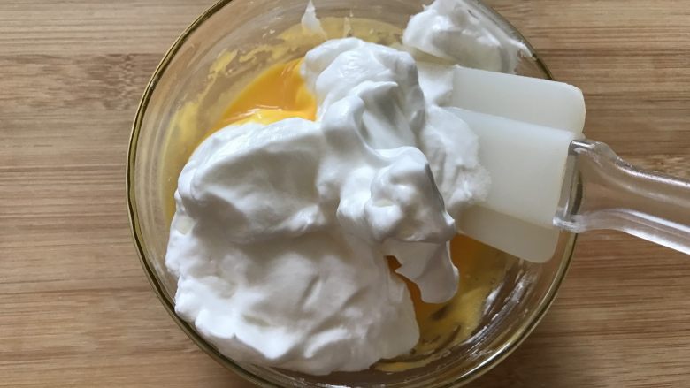 奶酪软曲奇,取三分之一蛋白霜放入蛋黄糊中混合均匀
