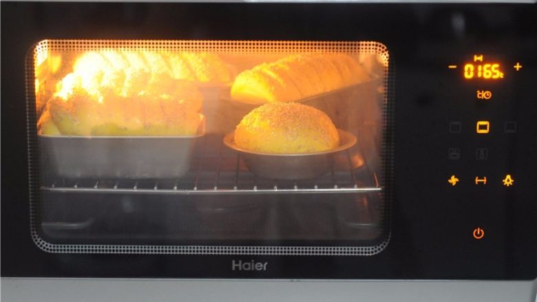 能量满满，南瓜红豆芝麻斑纹土司,将面包胚放入烤箱，165度烤10分钟后转下火烤23分钟