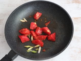 茄汁豆腐,锅内留底油，先煸香葱花，放入西红柿翻炒。