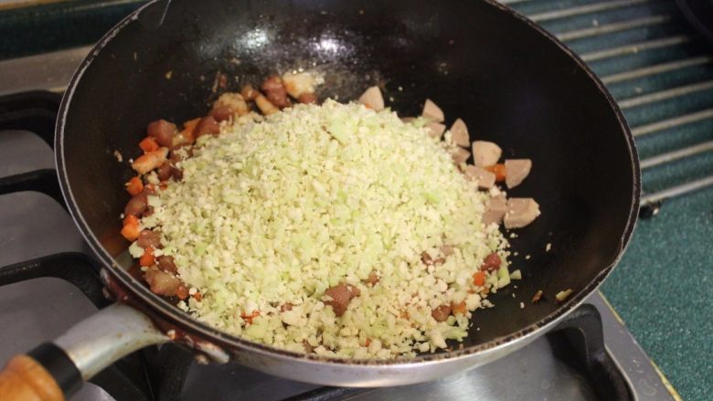 吃不胖的炒饭-花椰菜炒饭,将白花椰菜倒入炒锅，一起拌炒。