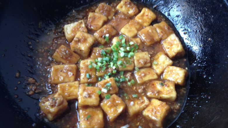 肉末豆腐,待汤汁浓稠后放入剩下的葱花，炒匀即可出锅