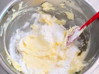 香酥曲奇花,将糖粉过筛后搅拌进软化的黄油中。