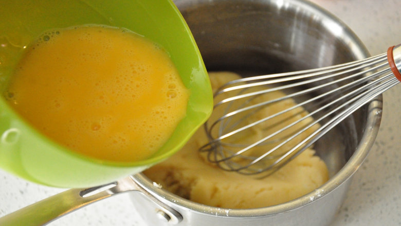 西班牙油条——吉拿果,面糊温热时分次加入全蛋液搅拌均匀。