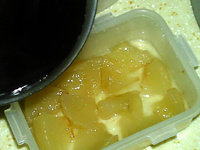 桃肉龟苓膏,保鲜盒中铺一层桃肉，倒入烧沸的龟苓膏液体