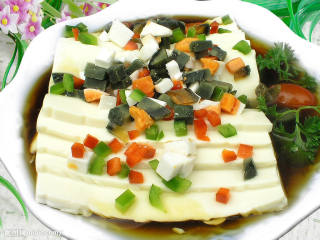皮蛋豆腐,将红油汁倒在摆好盘的豆腐皮蛋上,散上寸段的香菜即可。