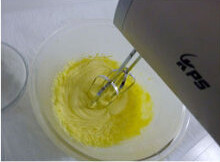橙香蛋糕,将软化好的黄油分次加入糖粉打至蓬松发白状态