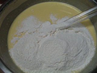 大理石乳酪蛋糕,加入黄油拌均，分次加入蛋黄，搅拌均匀，筛入粉类