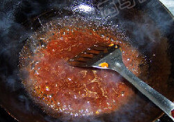 浇汁菊花鱼,熬煮片刻，加入一勺炸鱼的油。使芡汁更加红亮