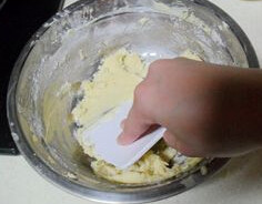 向日葵饼干,加入面粉和蛋液，拌匀用刮板以从内向外的方式挤压面团