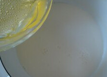 蜜红豆双皮奶 ,打散的蛋清倒入牛奶中，搅拌均匀，加2勺<a style='color:red;display:inline-block;' href='/shicai/ 869'>白砂糖</a>，搅均，过筛后倒入刚才有奶皮的碗里。