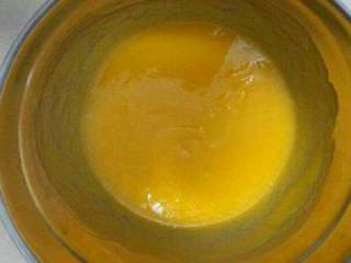 自制芒果慕斯蛋糕,将白砂糖加入芒果酱中 嗝温水加热至白砂糖化开。