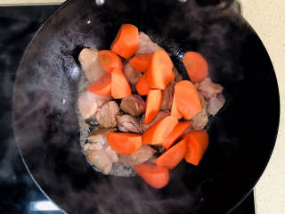 红烧羊肉煲,加入胡萝卜块，翻炒均匀