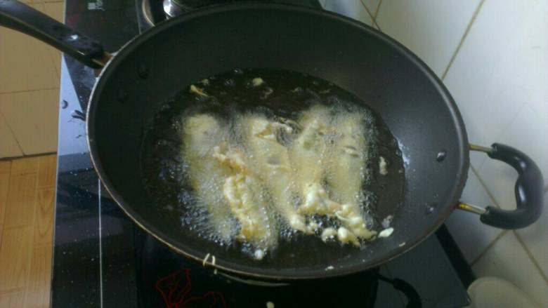 炸黄鱼,锅中放入大量油烧热，然后放入裹完面糊的小黄鱼，以小火炸至金黄色；