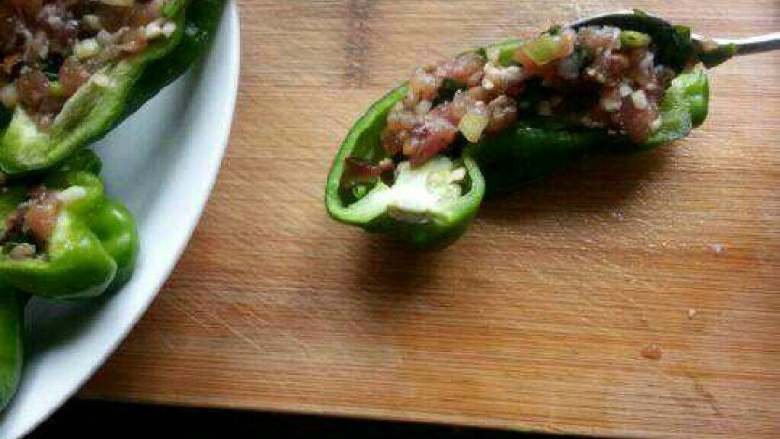 虎皮青椒酿肉,用勺子挖一点肉末放进青椒里。