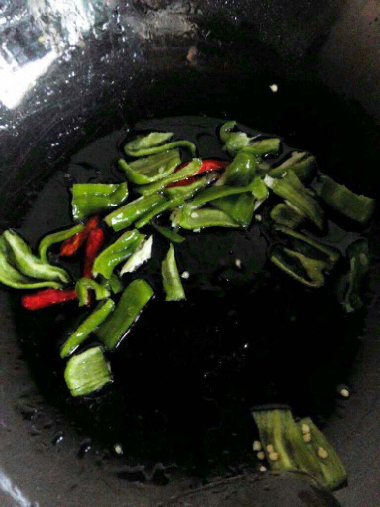 家常鱼香茄子,锅里在放适量油把青红椒放进去翻炒。