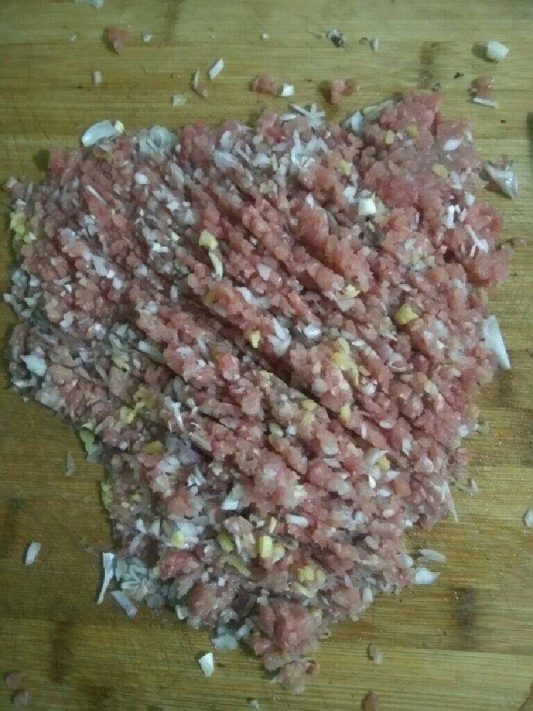 猪肉香菇水饺,把猪肉切成饺子陷，切的时候把葱和姜和肉一起切碎