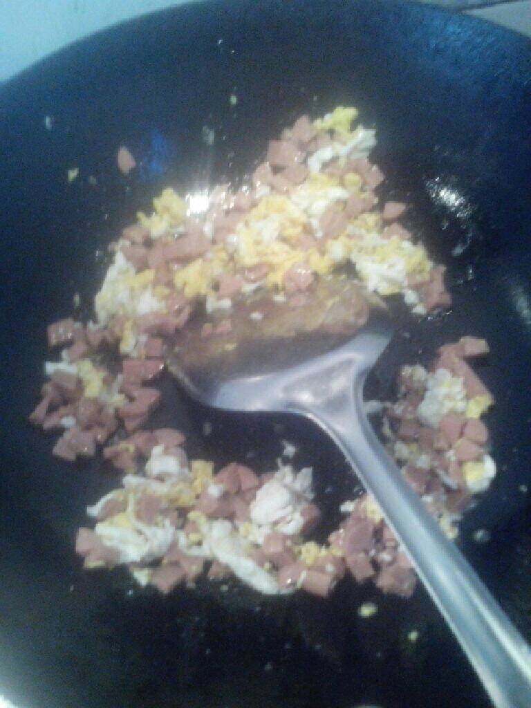 火腿蛋炒饭,把火腿丁倒入鸡锅搅拌均匀