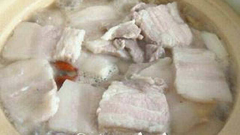 酸菜白肉的家常做法,把清洗干净的肉片码在砂锅里，盖上锅盖，开小火让它慢慢的咕嘟咕嘟去吧。