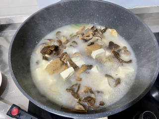 鲫鱼豆腐菇菌汤,汤色已经变得比较白，加入豆腐菌菇