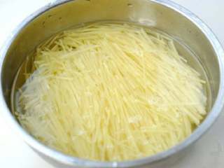 酸辣土豆丝,用清水将切好的土豆丝泡去淀粉，（这样炒出的土豆丝清爽不粘）。