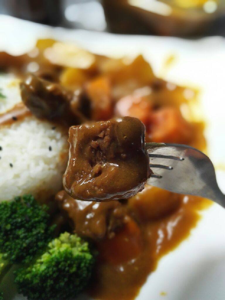 咖喱牛肉饭,把米饭放入碗中压实，倒扣在盘子。浇上咖喱牛肉即可。