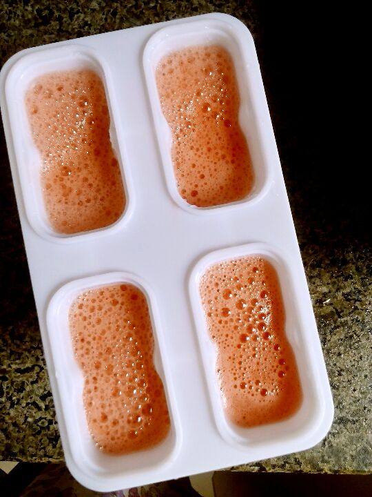 西瓜冰棍,用料理机榨好的西瓜汁倒入模具中。
