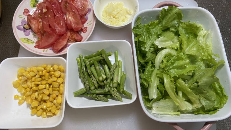 鸡胸肉蔬菜沙拉,改刀：生菜撕碎，芦笋去老皮切段，番茄切段，蒜切末