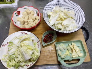 白菜烩小酥肉,白菜帮白菜叶分开切段，葱白切段，蒜切片，姜切片，干辣椒剪小段，冻豆腐焯水去腥，挤干水分备用