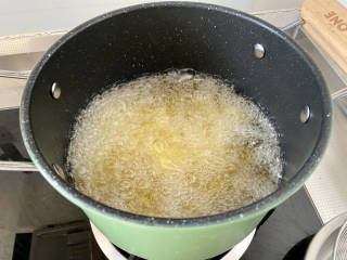土豆回锅肉,土豆片洗去表面淀粉沥水，锅中加入宽油，油温7成热，下土豆片中小火炸2分钟，土豆片变硬盛出沥油
