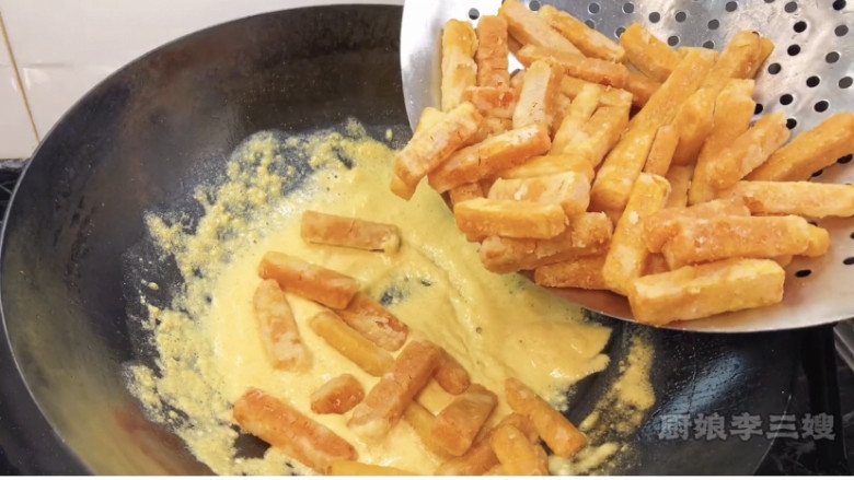 香甜酥脆的蛋黄焗南瓜制作方法,把炸好的南瓜放锅中翻拌均匀出勺