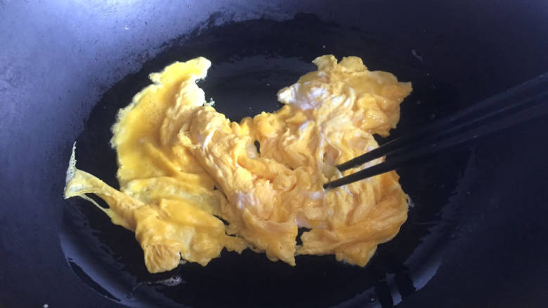 鸡蛋配蒜苔,热锅倒油，倒入鸡蛋液，炒至凝固盛出备用